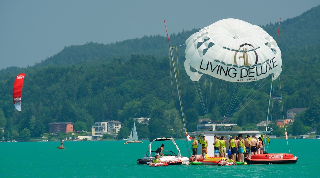 Velden am Woerthersee showing a bay or harbour as well as a small group of people