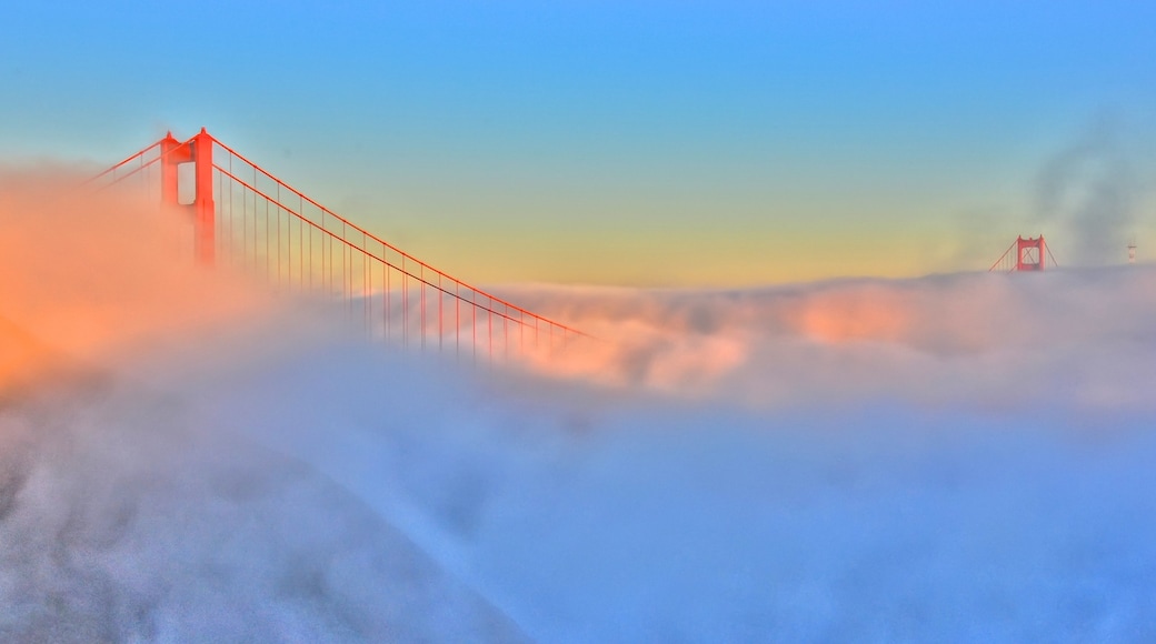 Golden Gate Bridge showing mist or fog and a bridge