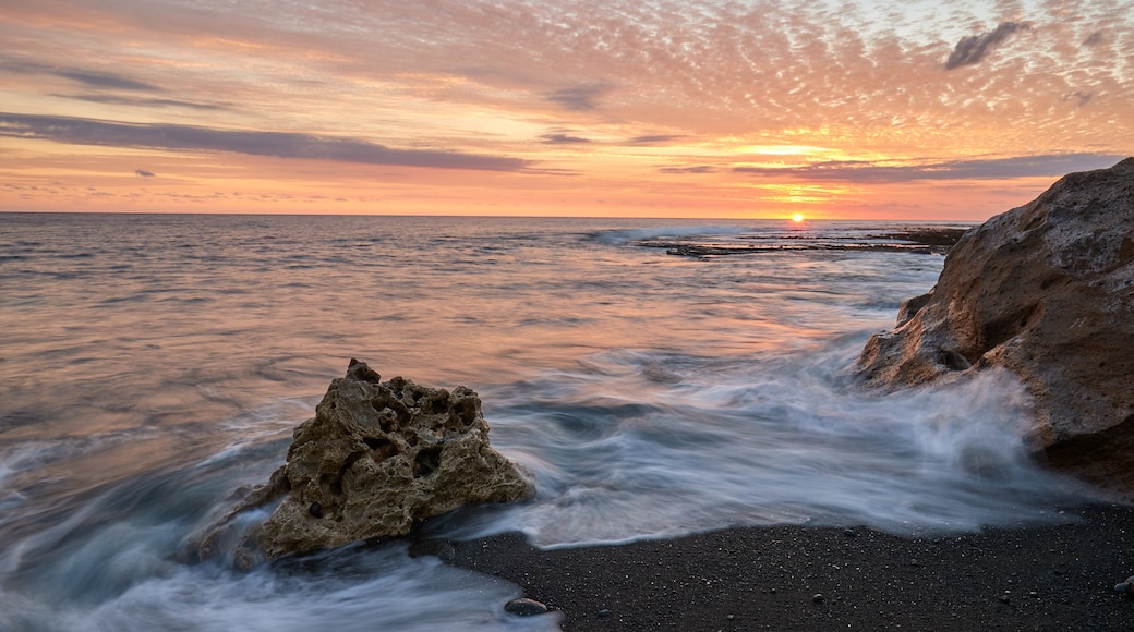 Tanna Island featuring rocky coastline, general coastal views and a sunset