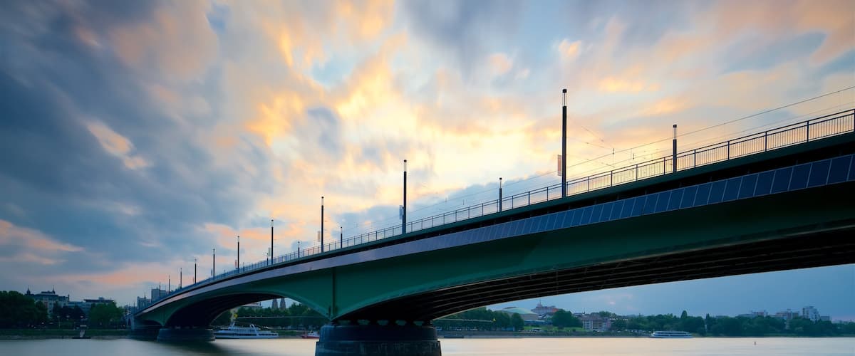 North Rhine-Westphalia which includes a bridge, a river or creek and a sunset