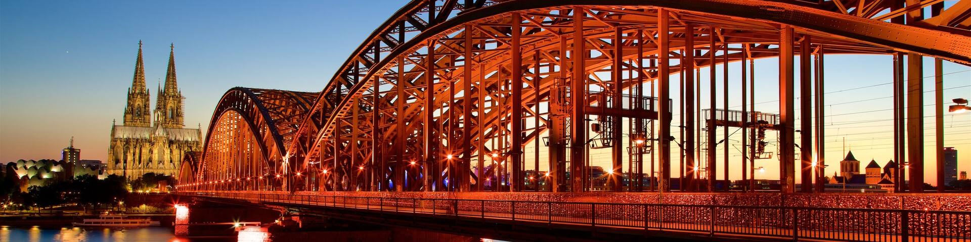 Hohenzollern Bridge showing a bridge, a sunset and a river or creek
