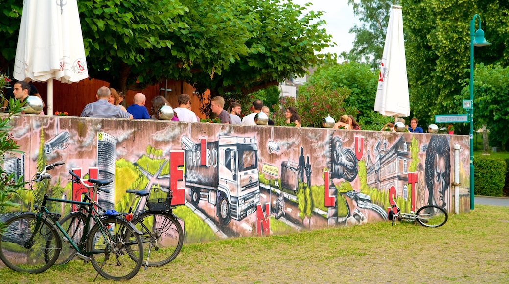 Kennedy Bridge showing outdoor art and outdoor eating as well as a small group of people