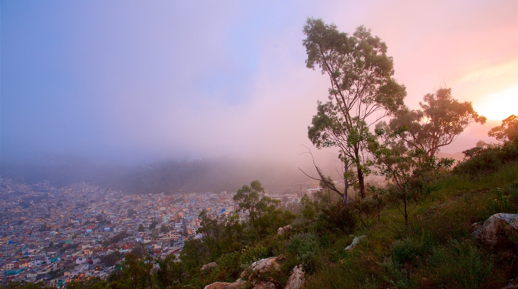 Pachuca showing a city, mist or fog and a sunset