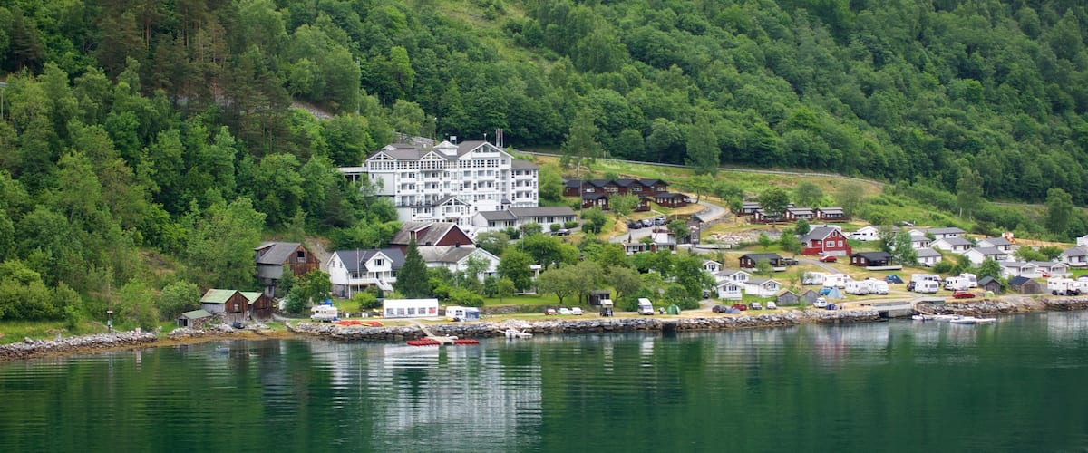 Geiranger which includes a small town or village and a river or creek