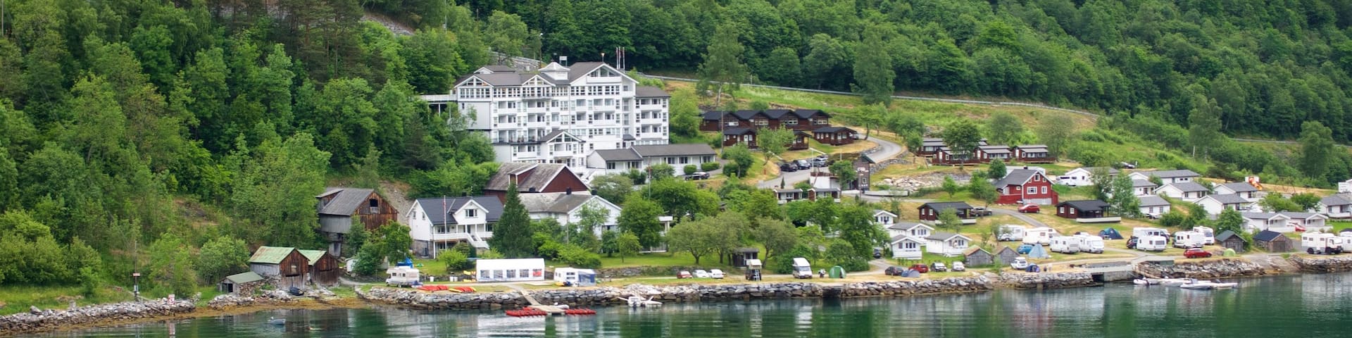 Geiranger which includes a small town or village and a river or creek