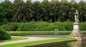 Bremen Buergerpark showing a garden, a statue or sculpture and a lake or waterhole