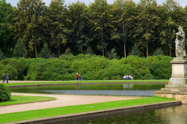 Bremen Buergerpark featuring a lake or waterhole, a statue or sculpture and a park