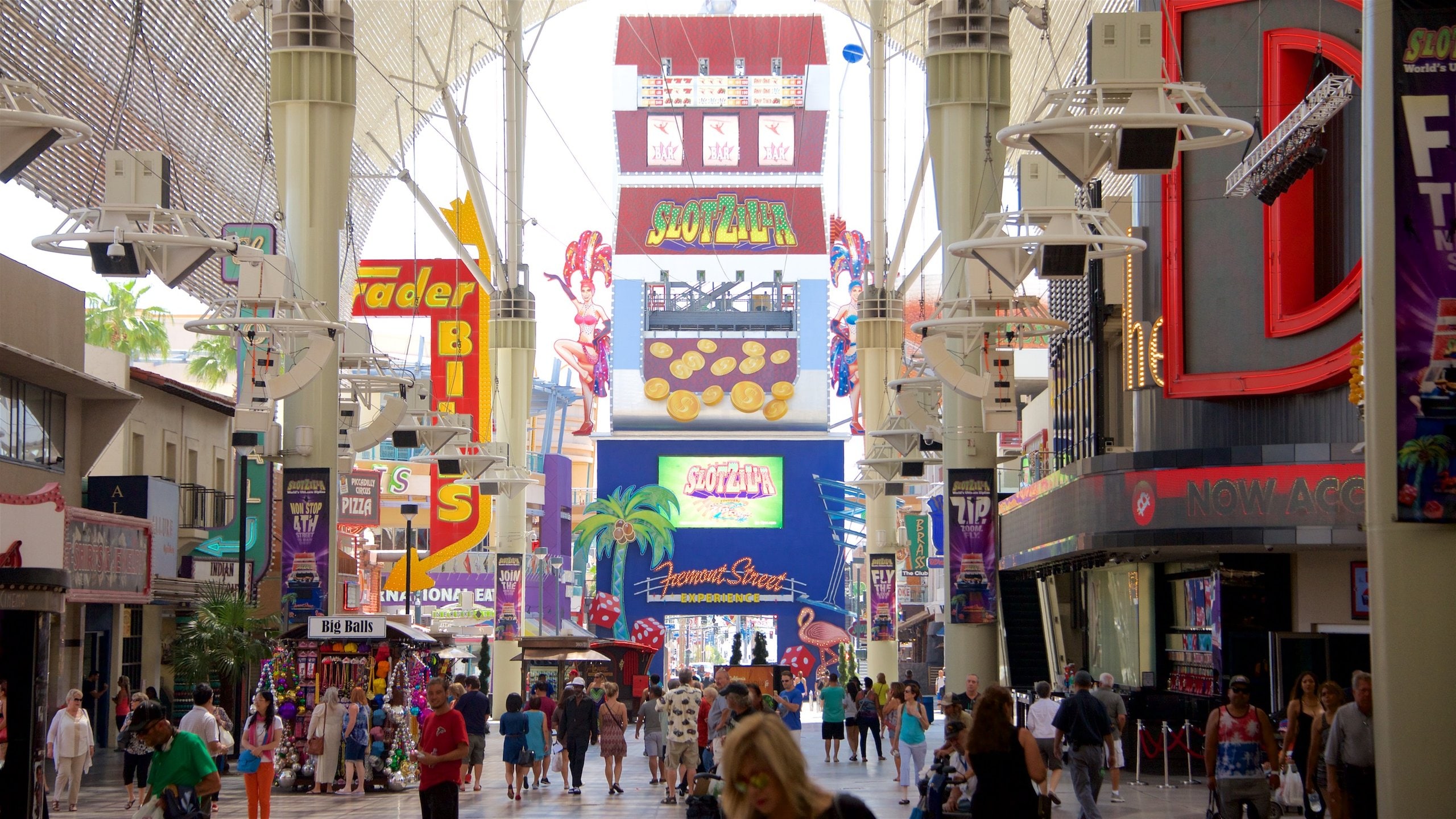 Downtown Las Vegas showing signage as well as a small group of people