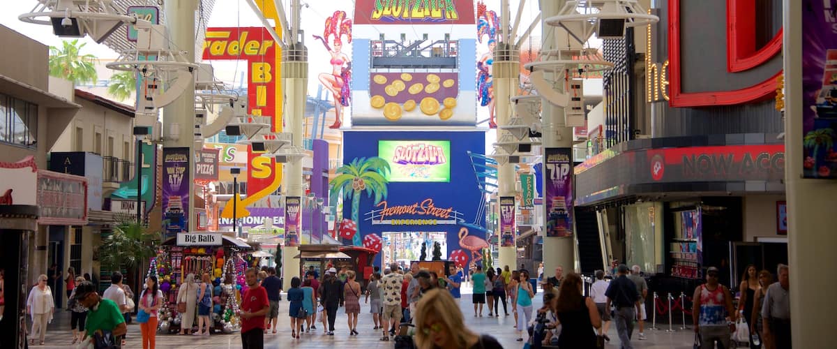 Downtown Las Vegas featuring signage as well as a small group of people
