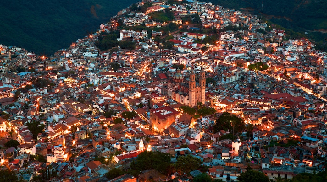 Santa Prisca Cathedral which includes a city and night scenes