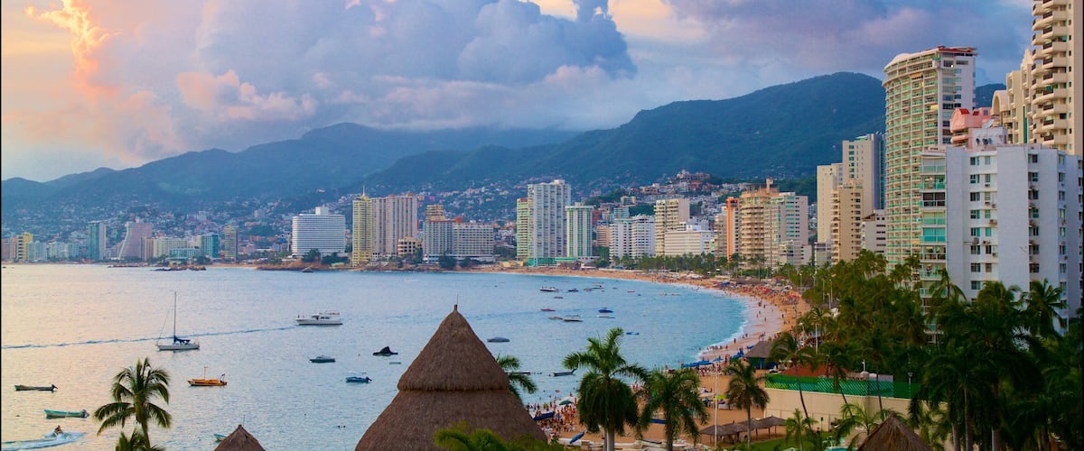 Acapulco featuring general coastal views, a city and a sunset