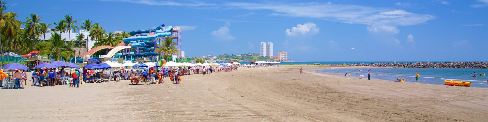 Mocambo Beach which includes a sandy beach as well as a large group of people
