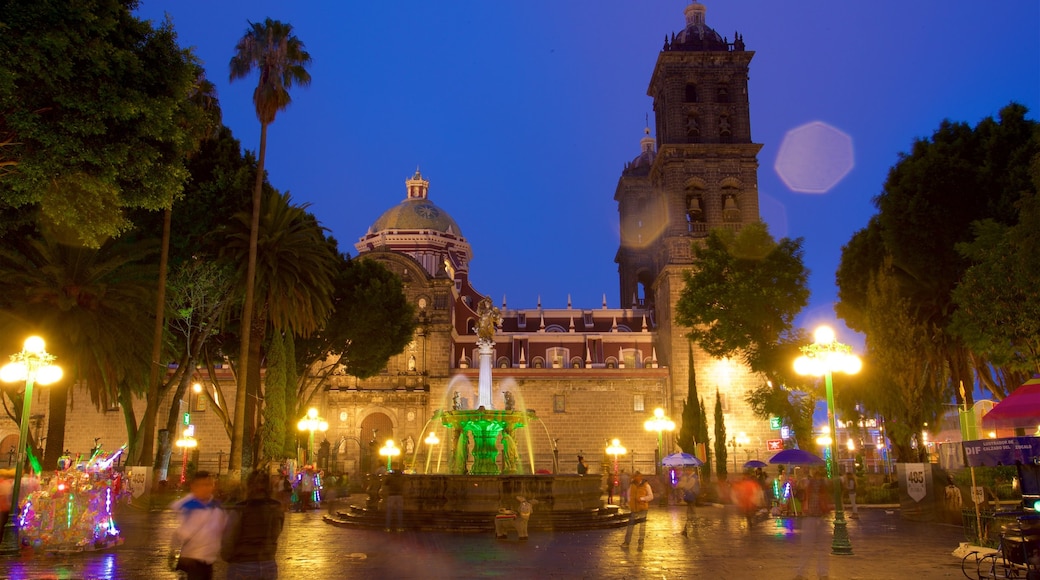 Puebla Cathedral which includes night scenes, a fountain and a square or plaza