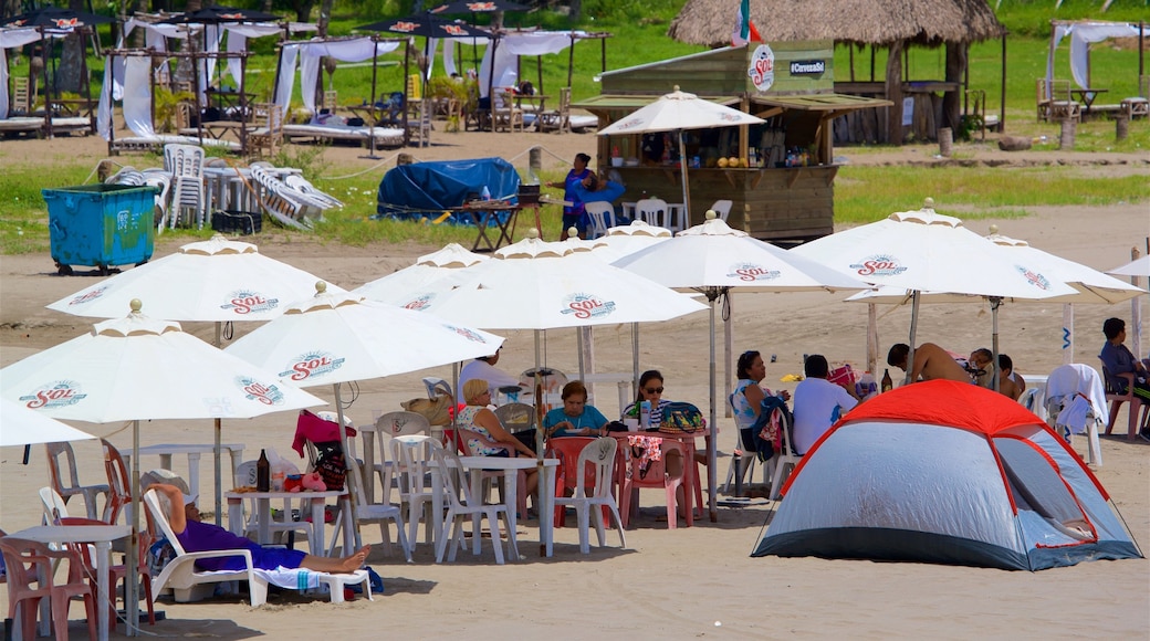 Mocambo Beach featuring a beach as well as a small group of people