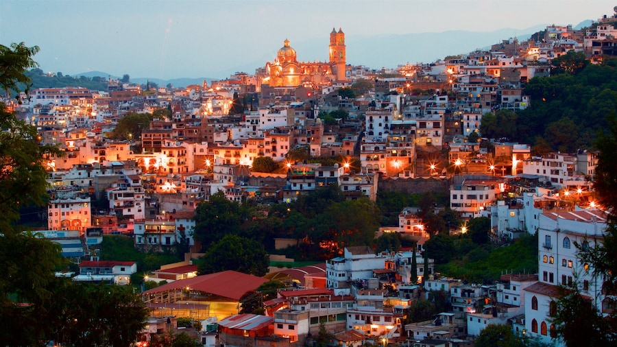 Santa Prisca Cathedral showing a sunset, a city and landscape views