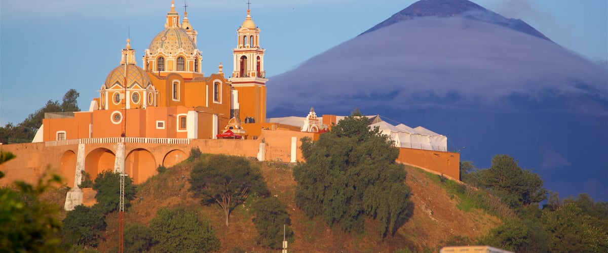 La Virgen de los Remedios Sanctuary showing mountains, heritage elements and a sunset
