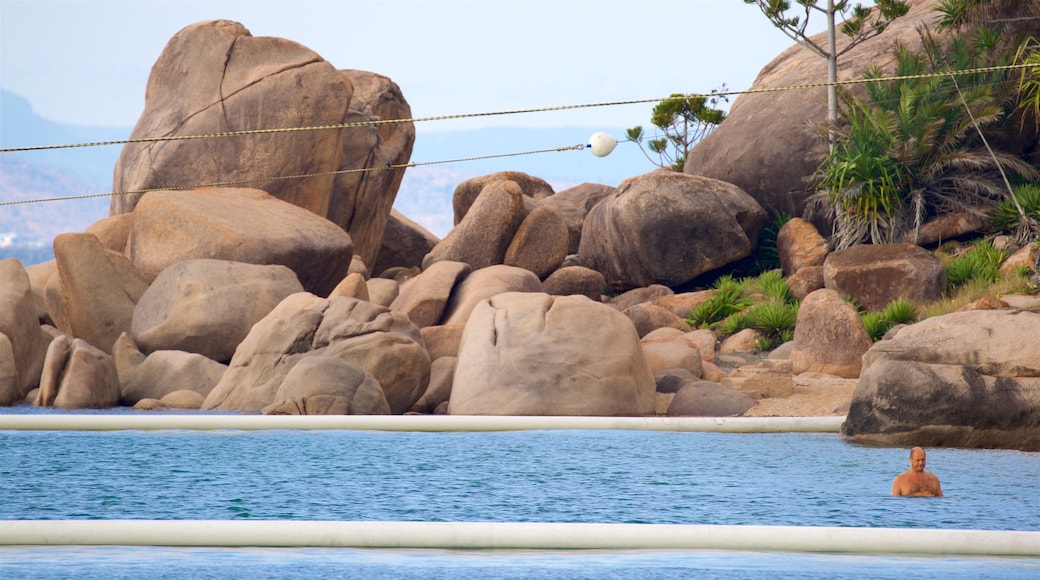 Picnic Bay showing swimming, general coastal views and rocky coastline