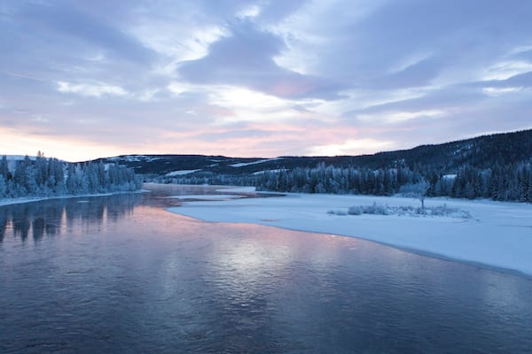 Are which includes a sunset, a river or creek and snow