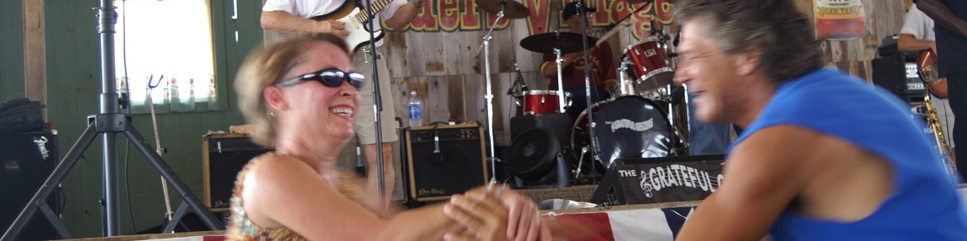 Traders Village featuring interior views and performance art as well as a couple