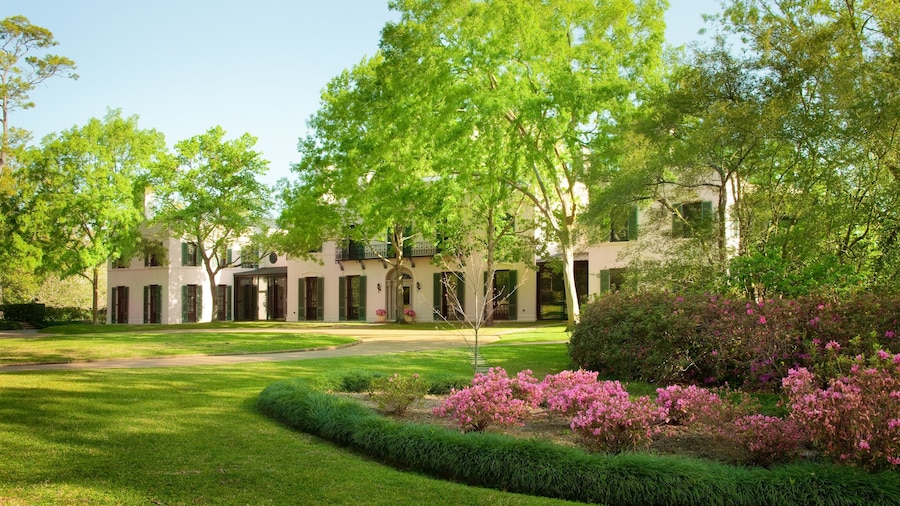 Bayou Bend Collection and Gardens in Houston featuring a historic mansion surrounded by blooming flowers and lush green lawns.