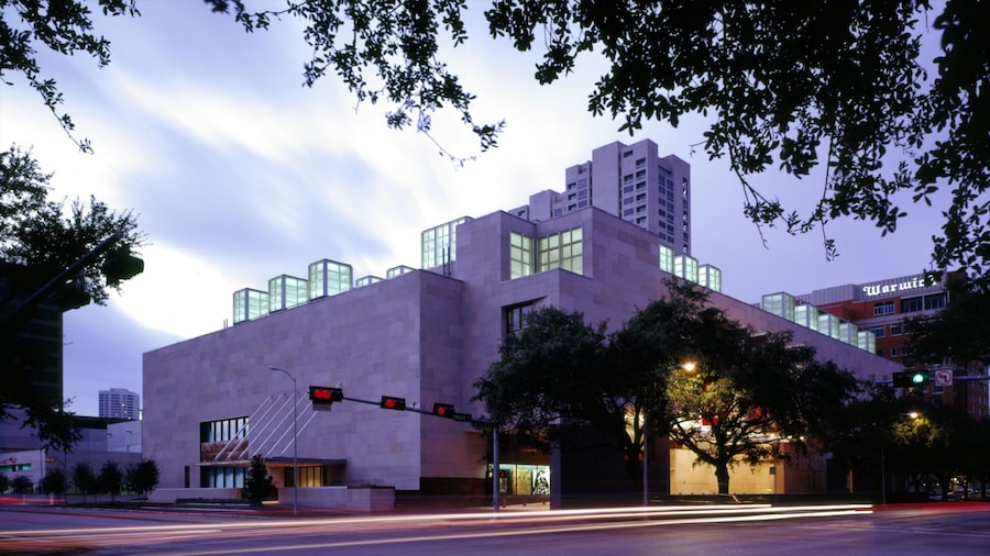 Houston Museum of Fine Arts exterior at dusk, featuring modern architecture and glowing glass skylights in the Museum District.