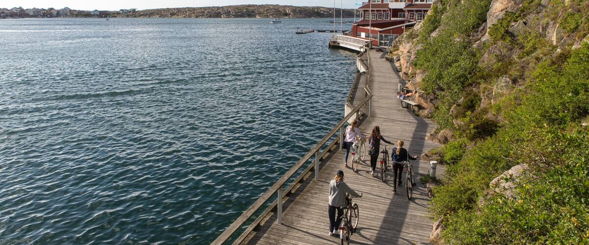 Kungshamn showing a lake or waterhole as well as a small group of people