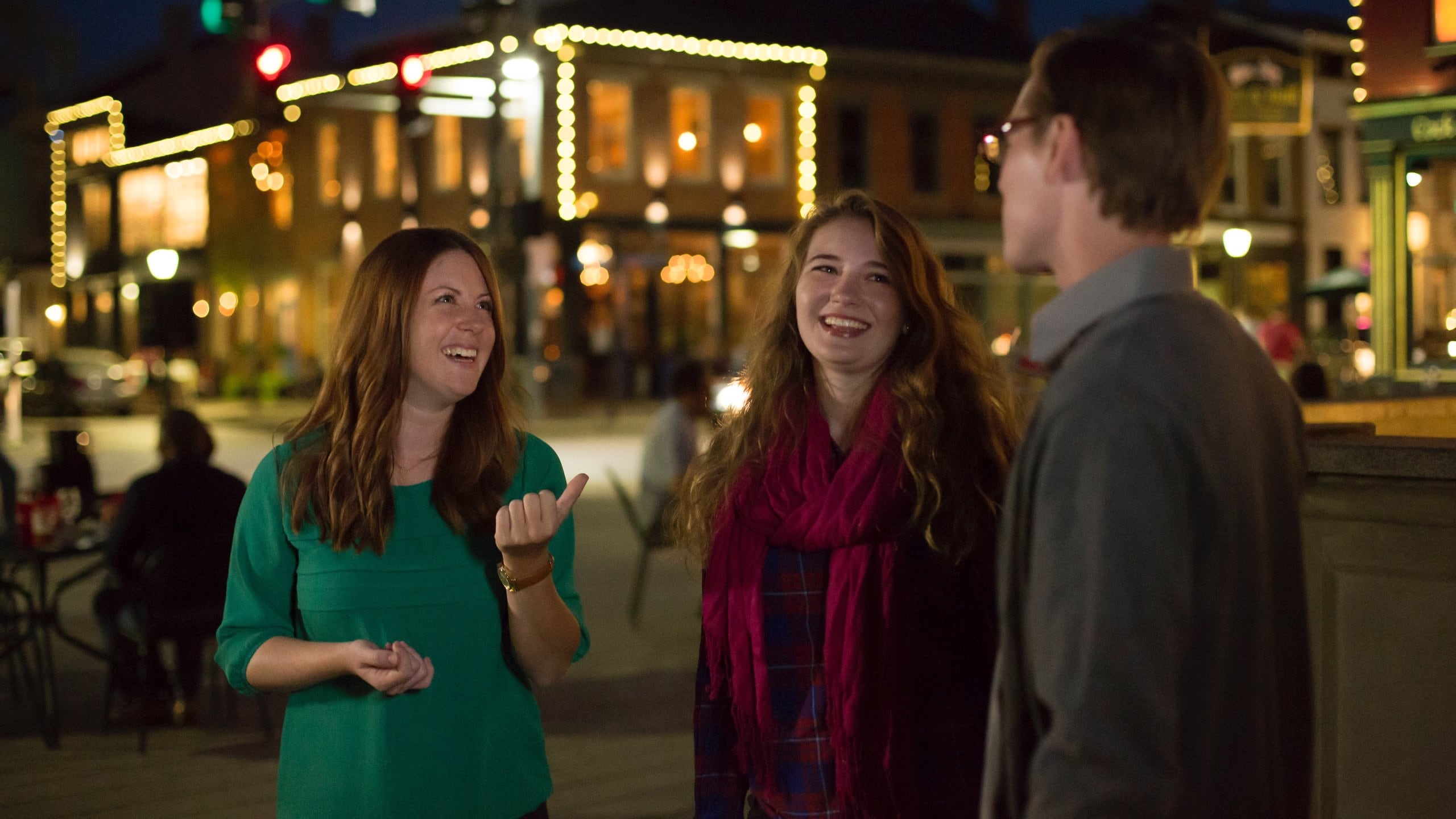 MainStrasse Village showing night scenes as well as a small group of people