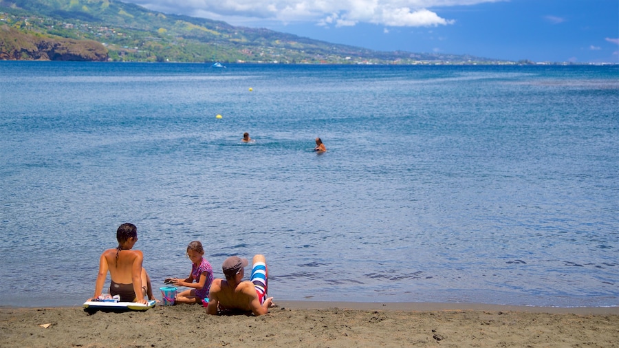 Black Sand Beach featuring general coastal views as well as a family