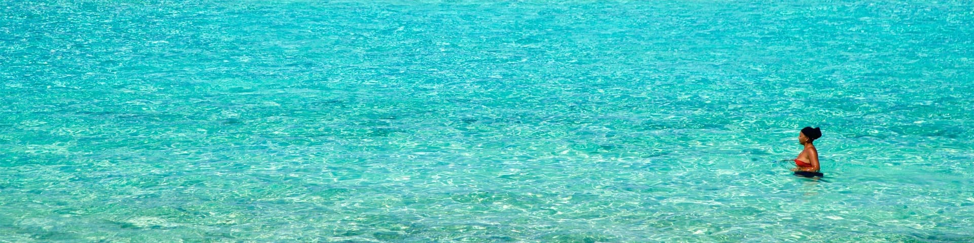 Matira Beach featuring swimming, tropical scenes and general coastal views