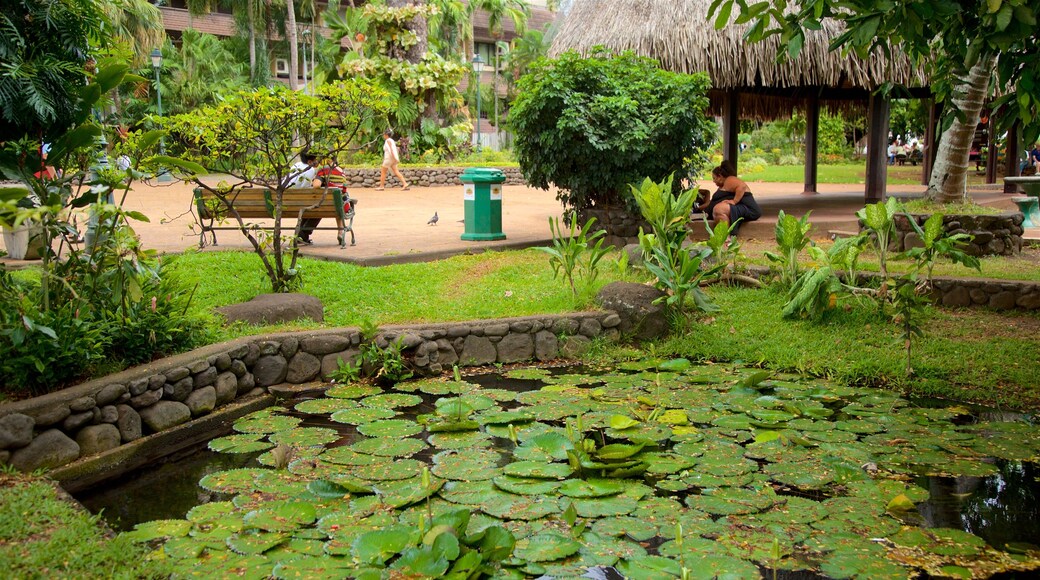 Parc Bougainville which includes a pond and a park