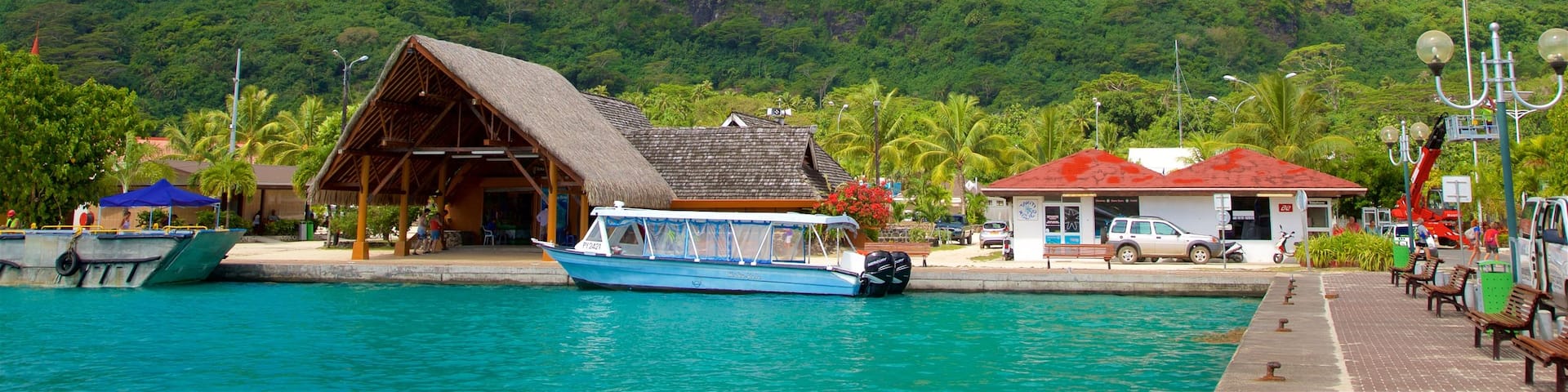 Vaitape Harbor which includes general coastal views, mountains and tropical scenes