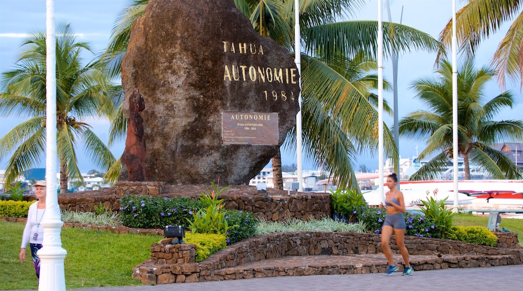 Papeete featuring signage and a garden as well as an individual female