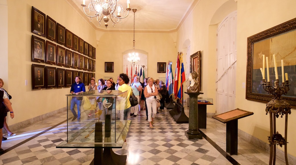 Capitanes Generales Palace showing château or palace and interior views as well as a small group of people