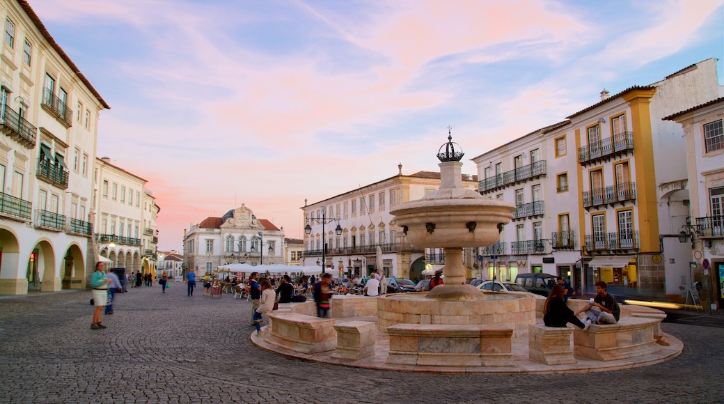 Praca do Giraldo featuring a sunset, a fountain and a square or plaza