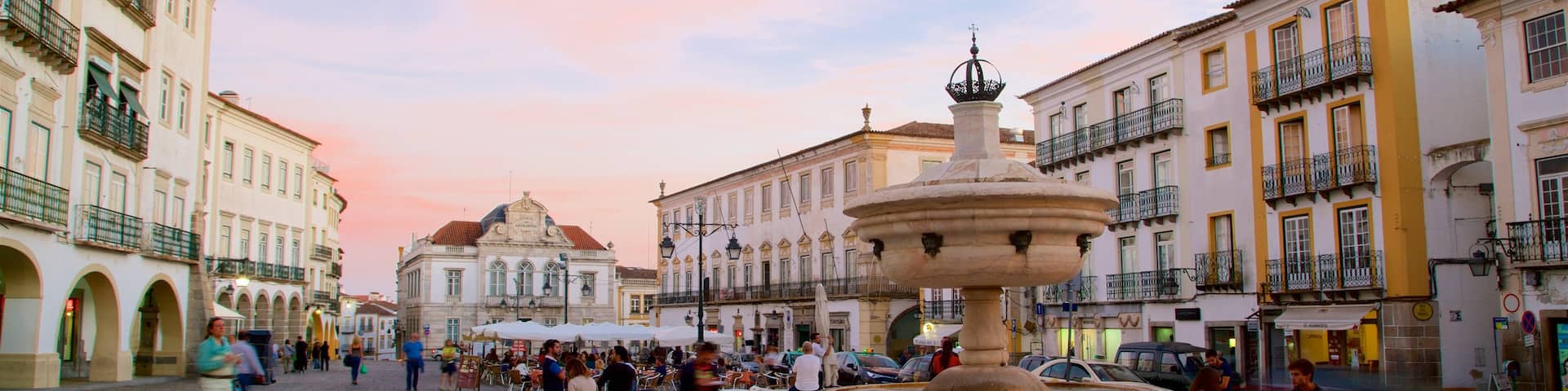 Praca do Giraldo featuring a square or plaza, a sunset and a fountain
