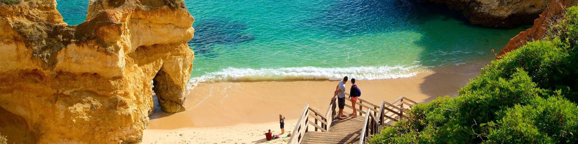 Camilo Beach which includes rocky coastline, a beach and general coastal views