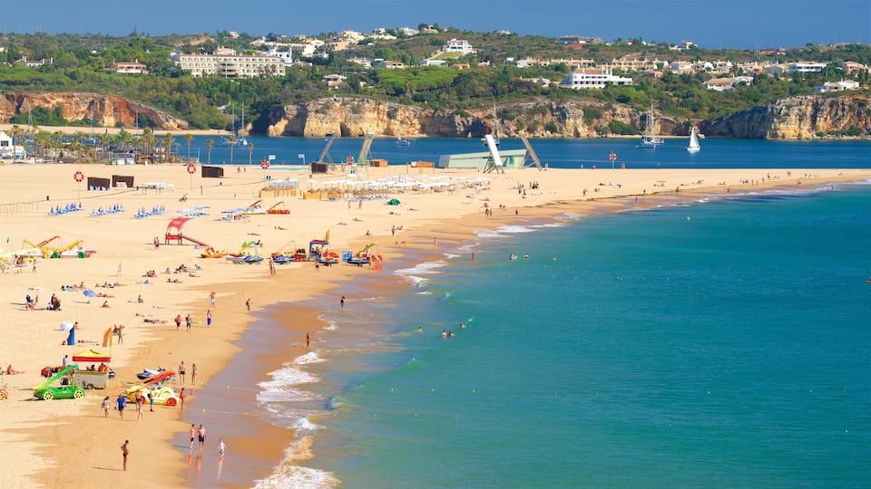 Rocha Beach showing a beach and general coastal views as well as a large group of people