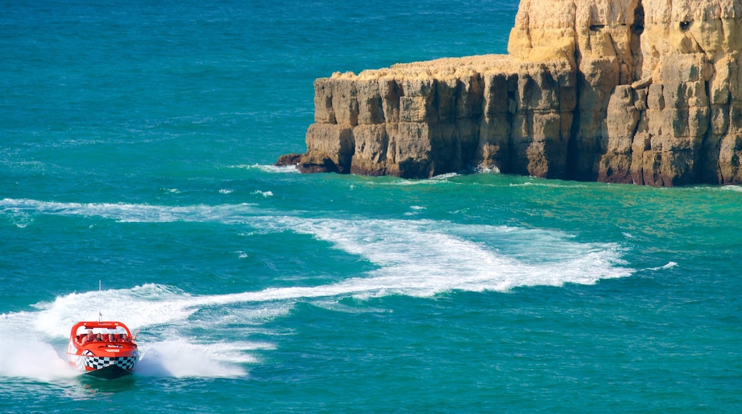 Coelha Beach featuring rocky coastline, boating and general coastal views