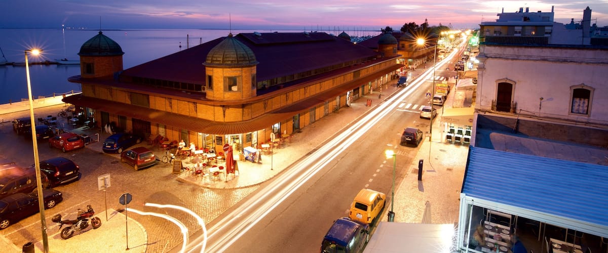 Olhao Municipal Market showing night scenes and a sunset