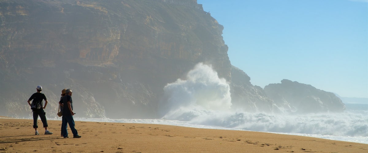 Norte Beach featuring a sandy beach, surf and rocky coastline