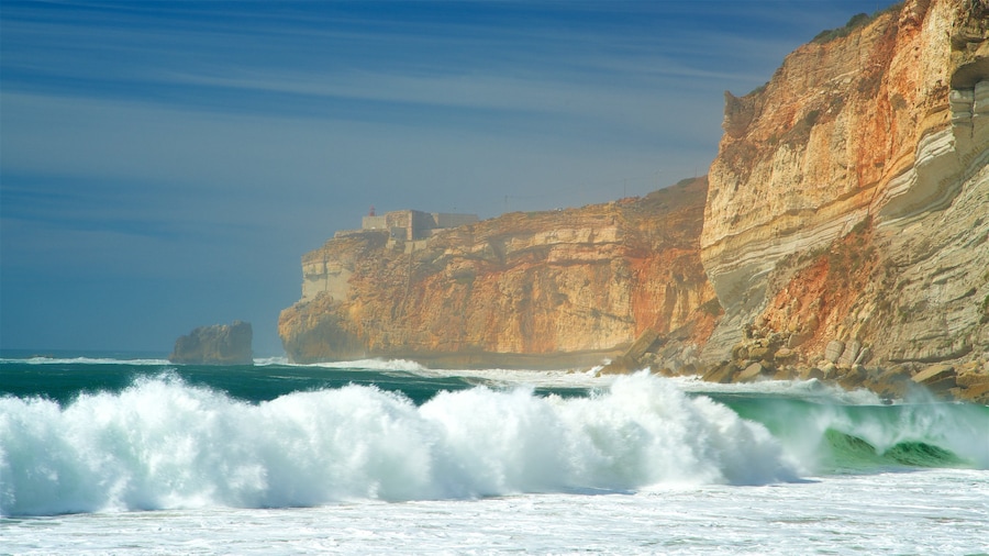 Nazare Beach showing waves, rocky coastline and general coastal views