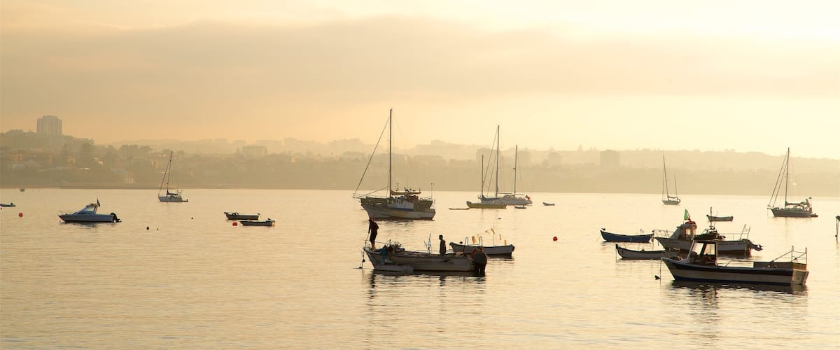 Cascais which includes a sunset and a bay or harbor