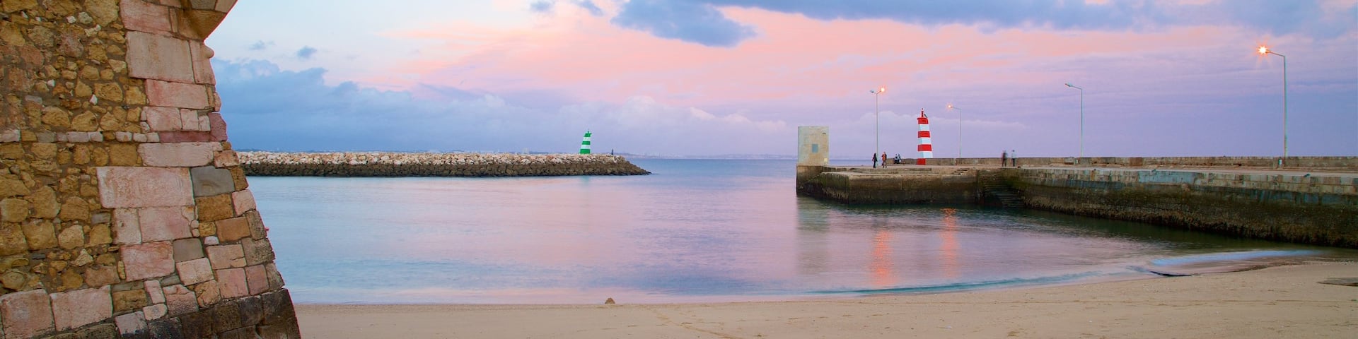 Lagos which includes a sandy beach, a sunset and general coastal views