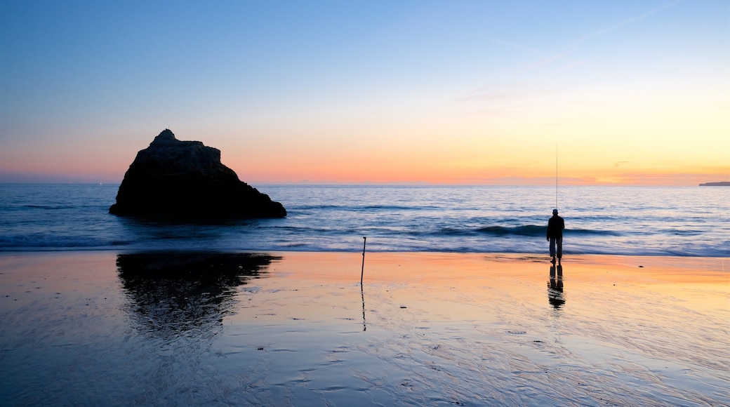 Tres Irmaos Beach featuring a sandy beach, fishing and a sunset