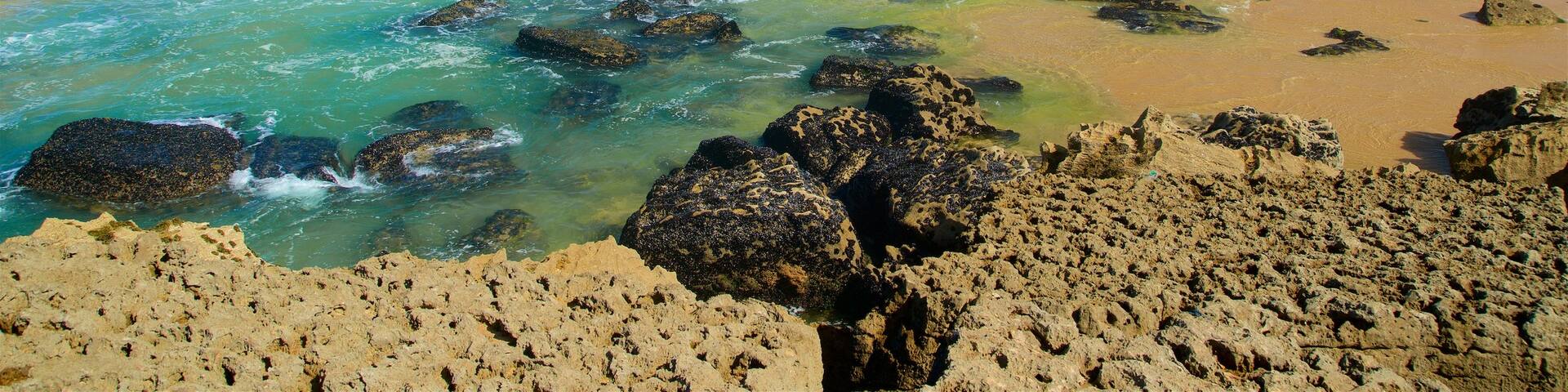 Macas Beach showing rocky coastline, general coastal views and waves