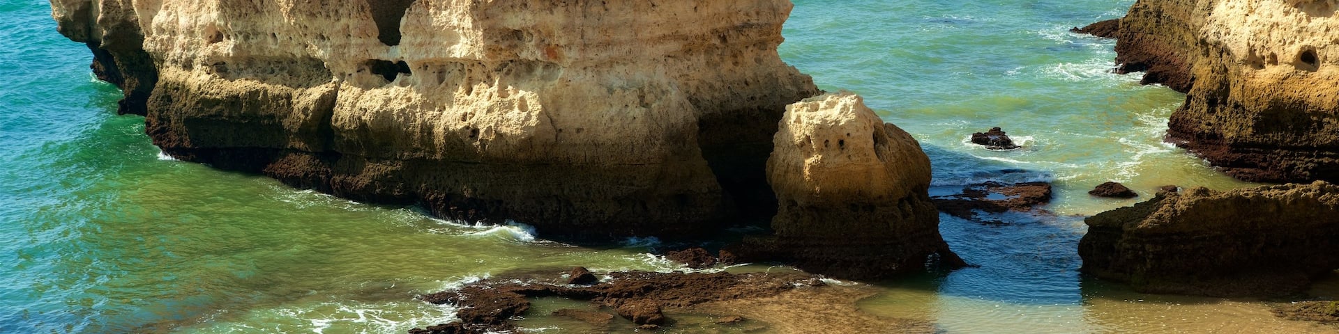 Coelha Beach which includes rugged coastline and general coastal views