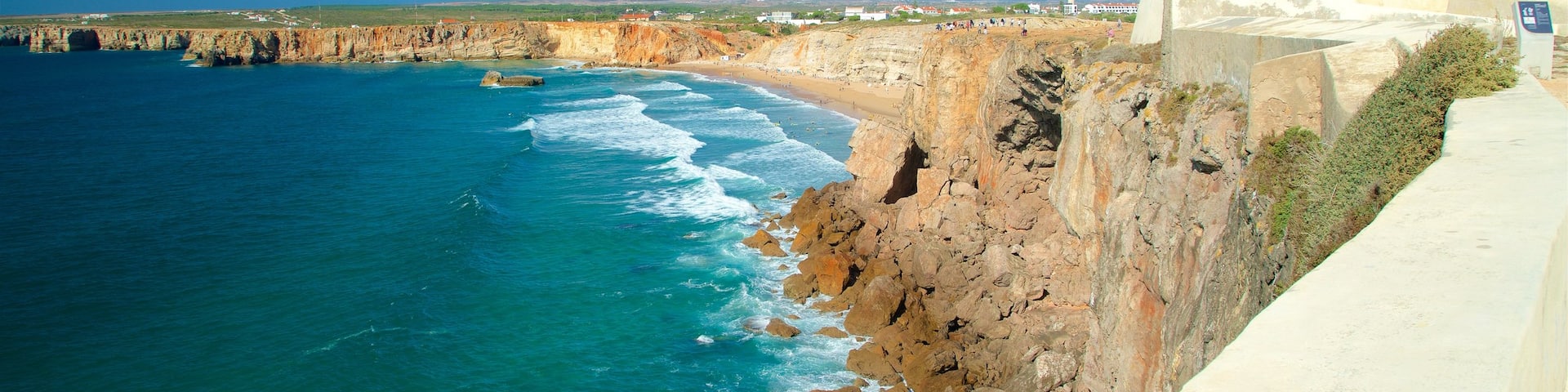 Sagres Fortress showing rocky coastline, a sandy beach and general coastal views