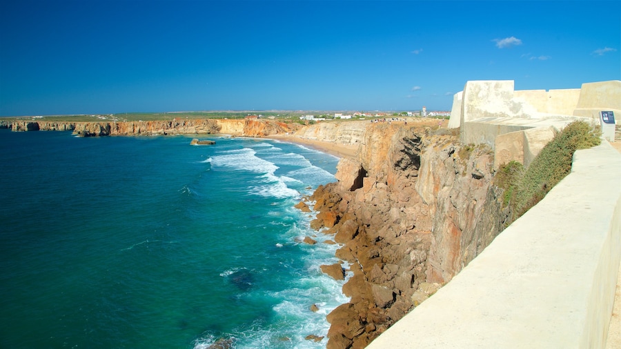 Sagres Fortress showing rocky coastline, a sandy beach and general coastal views