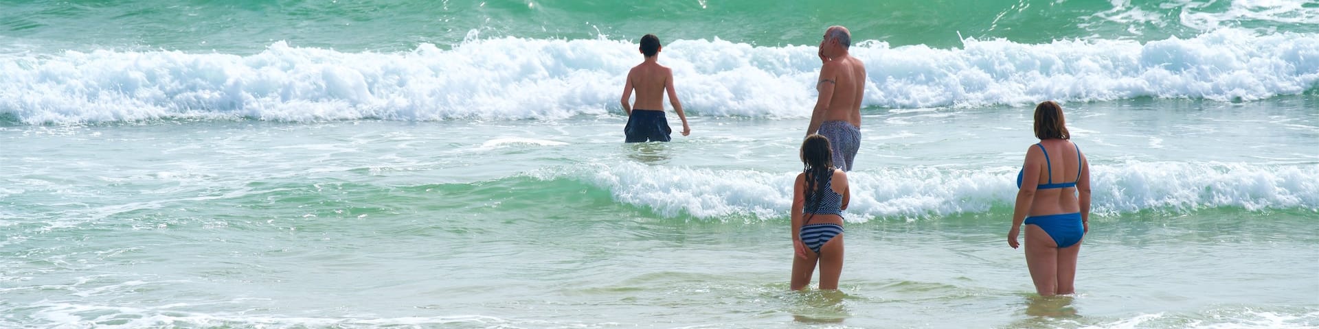 Fuzeta Beach showing general coastal views and surf as well as a family