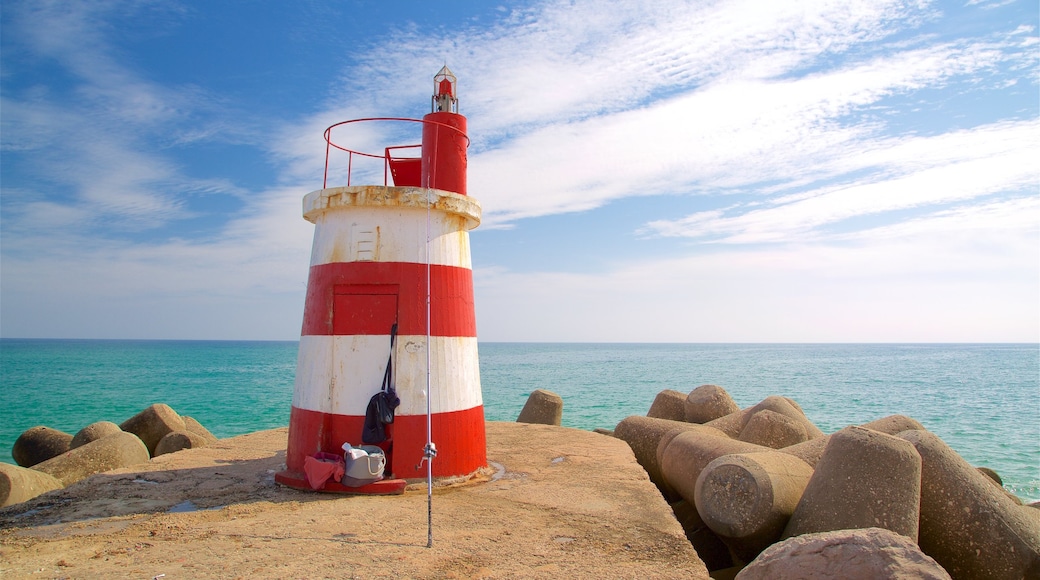 Ilha de Tavira Beach featuring a lighthouse and general coastal views